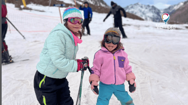 Girls in ski gear in the snow