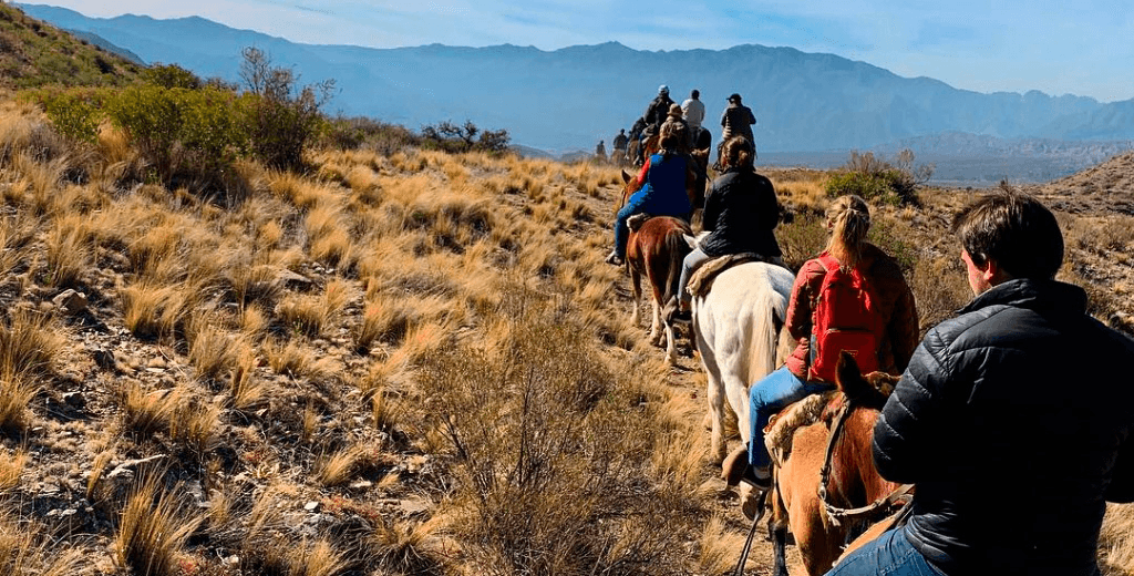 Line of riders crossing the countryside