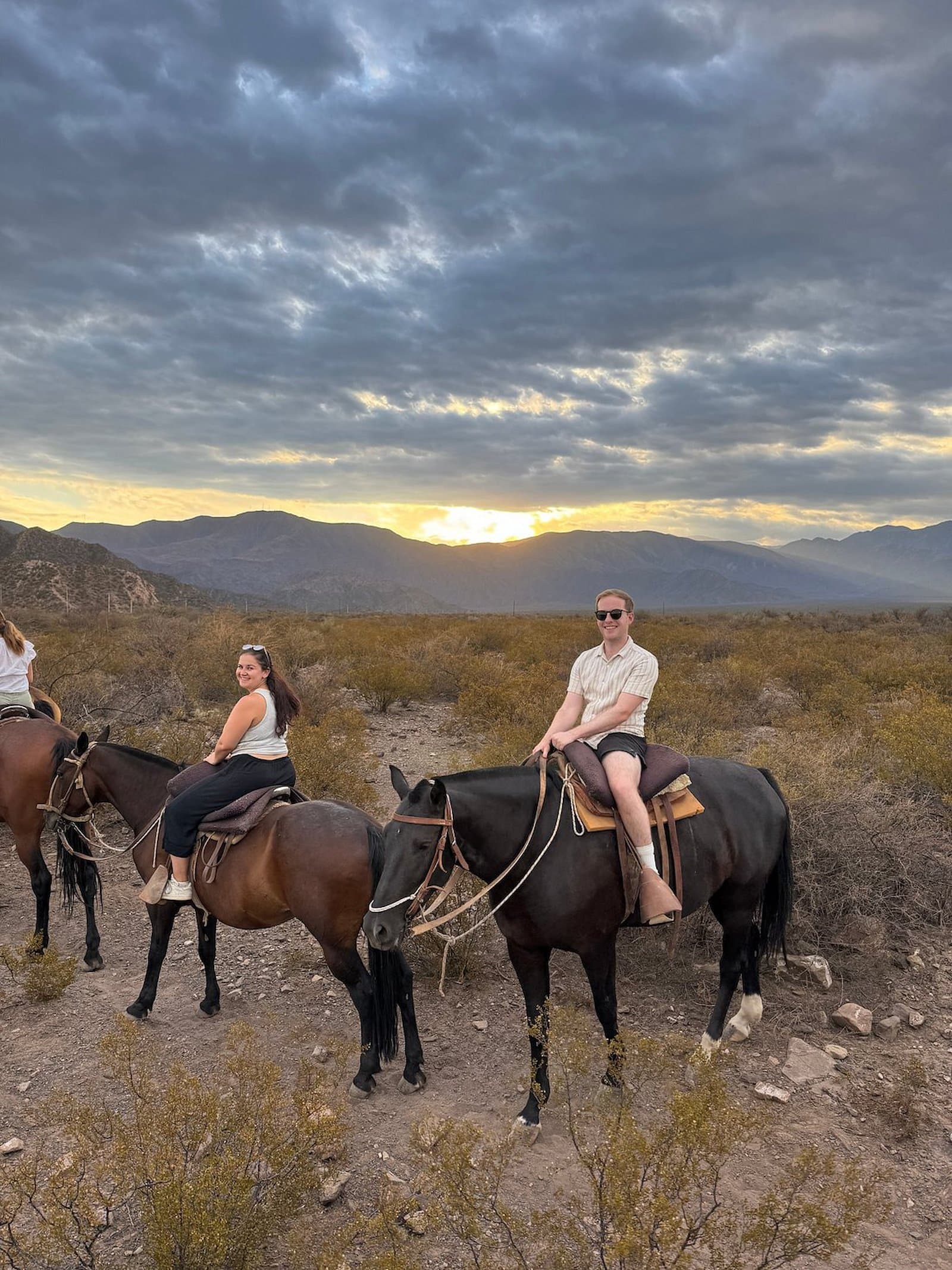 Riders on horseback at sunset in Mendoza